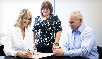 Three People Filling-Up The Form Sheet